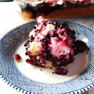 A piece of Black Raspberry Cake on a plate.
