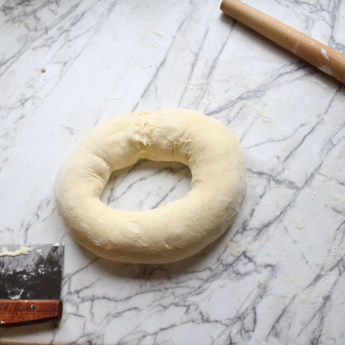 Swedish cardamom coffee cake ring after it has been rolled up and ends connected to form a circle.