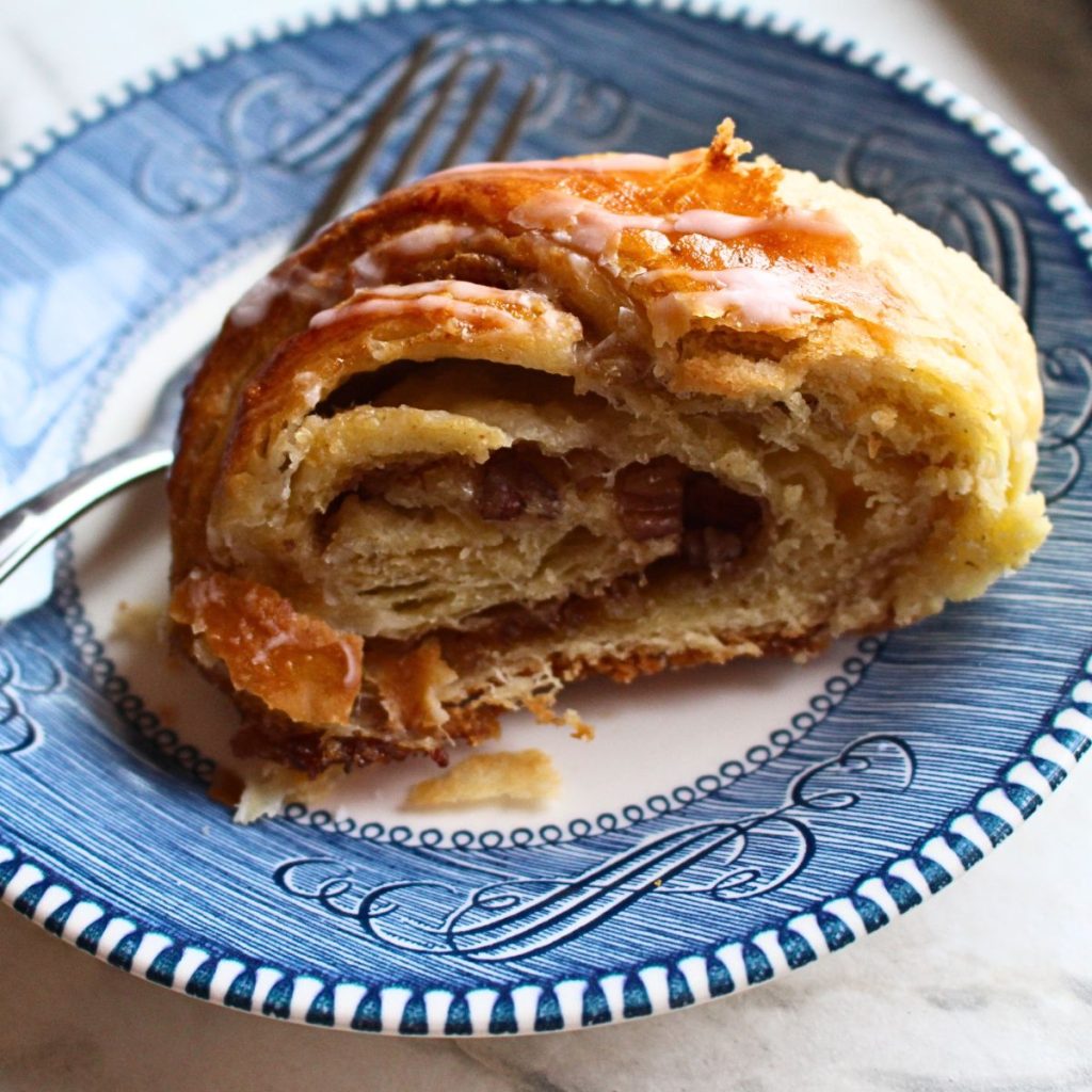 A piece Swedish cardamom coffee cake tea ring on a plate.