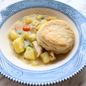 Homemade Chicken pot pie with biscuits served in a bowl.