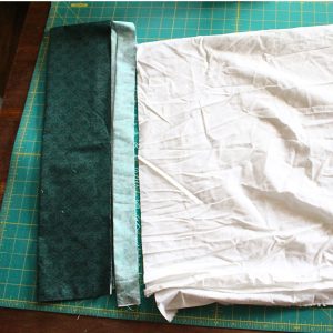 The three pieces of pillowcase lined up after cutting them to the specific measurements.