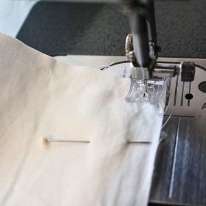 A close up of sewing the pillowcase together and showing the process of pivoting.