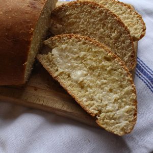 A close up of a Swedish Sweet Bread slice with butter on it.