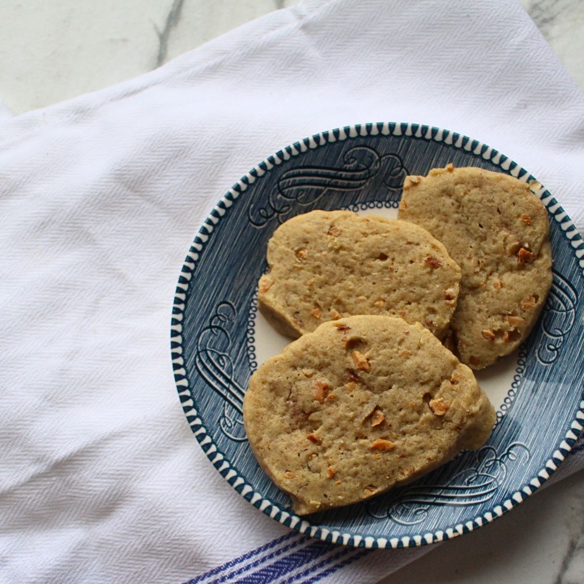 Three Almond Icebox Cookies on a plate.