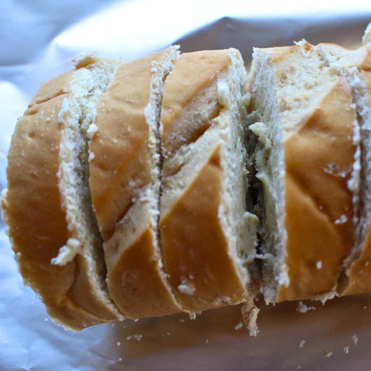 French bread slices with garlic butter on each side of the slice.