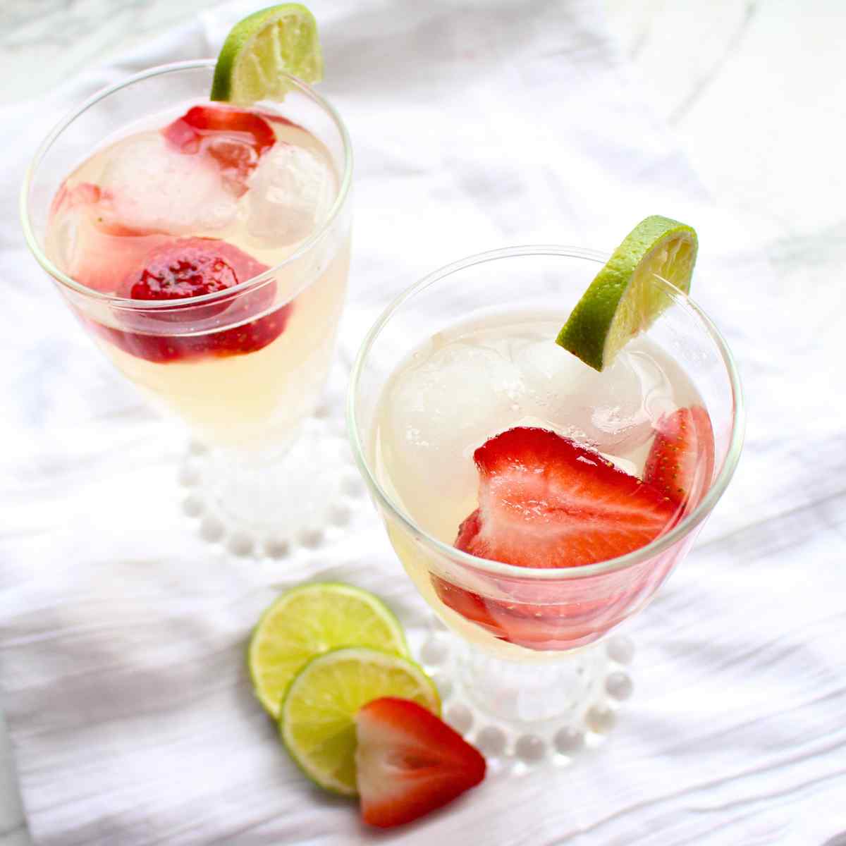 A top view of two glasses full of homemade strawberry limeade.