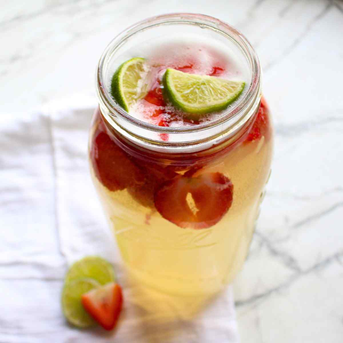 A mason jar full of homemade strawberry limeade.