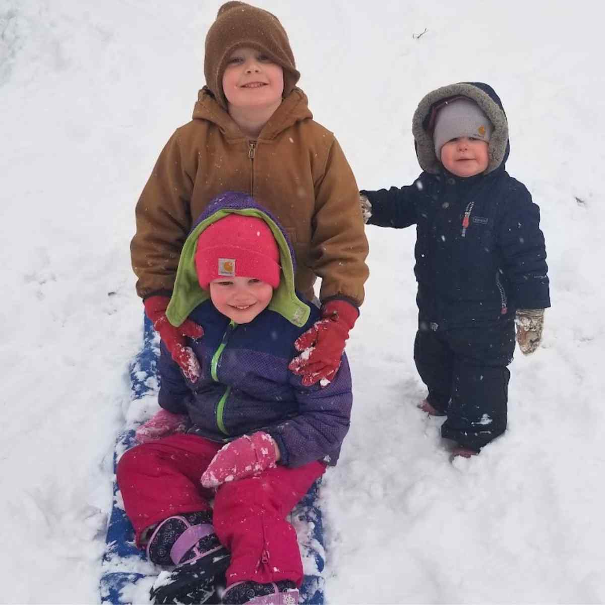 Three children in the snow.