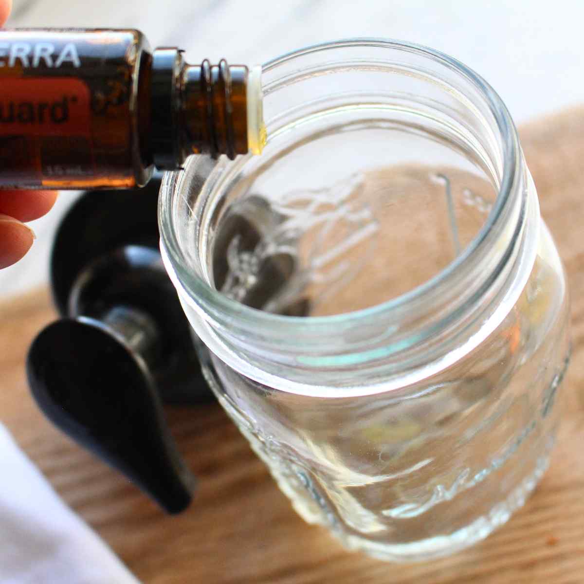 Essential oil drops being put into a foaming hand soap bottle.