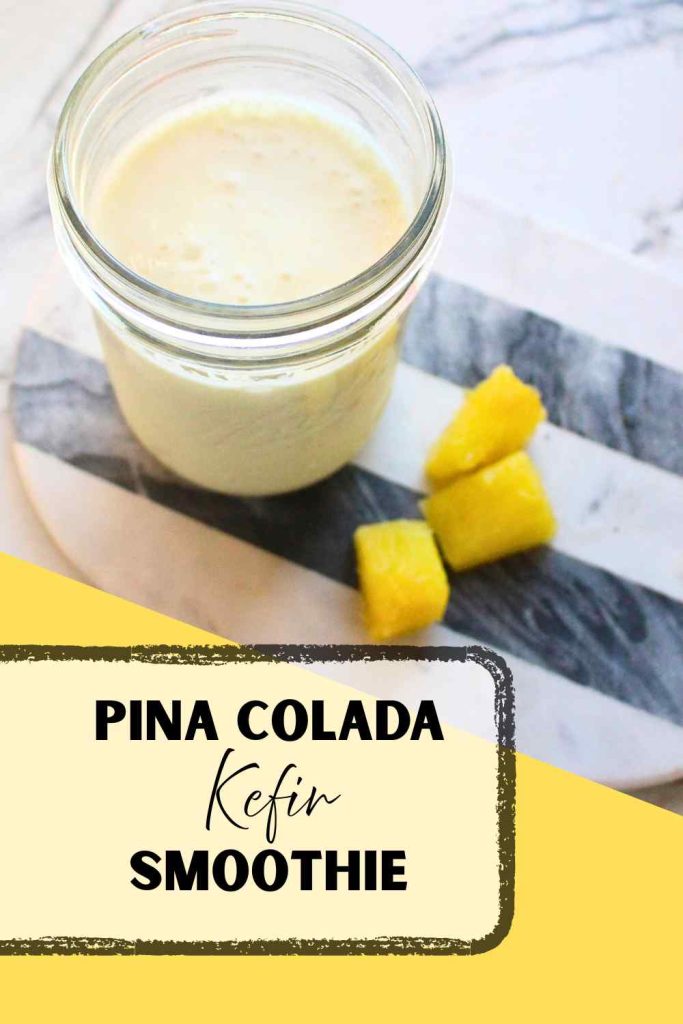 A mason jar of Pina colada kefir smoothie with pineapple pieces on the side, with the writing "Pina Colada Kefir Smoothie" on the bottom left of the picture.